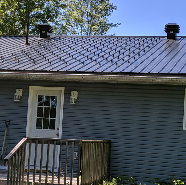 Sno-Safe Matte Black Snow Guards Protecting Door and Deck in Ontario